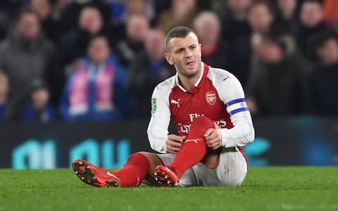 Jack Wilshere rolls up his socks - Credit: getty images