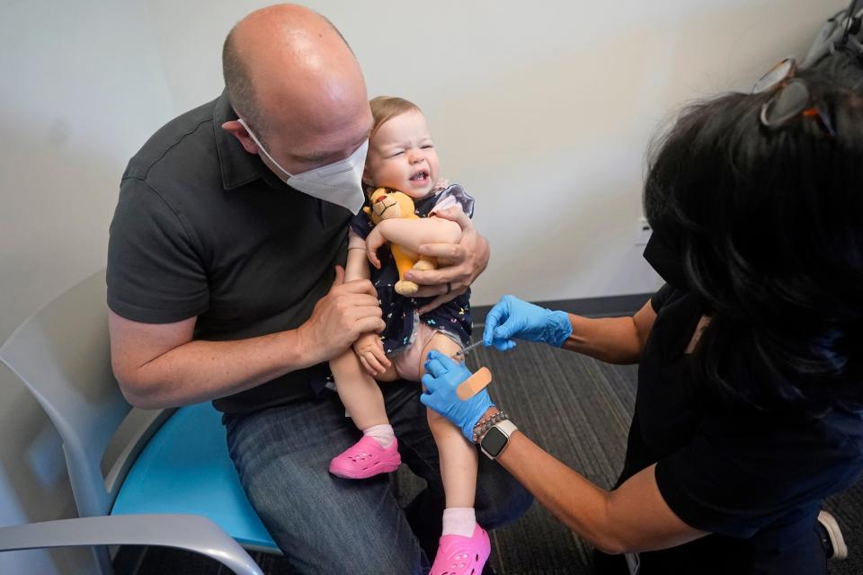 Michael Rupp holds his daughter Lennox, 16 months, as she receives the Moderna COVID-19 vaccination on June 21, 2022, in Salt Lake City.