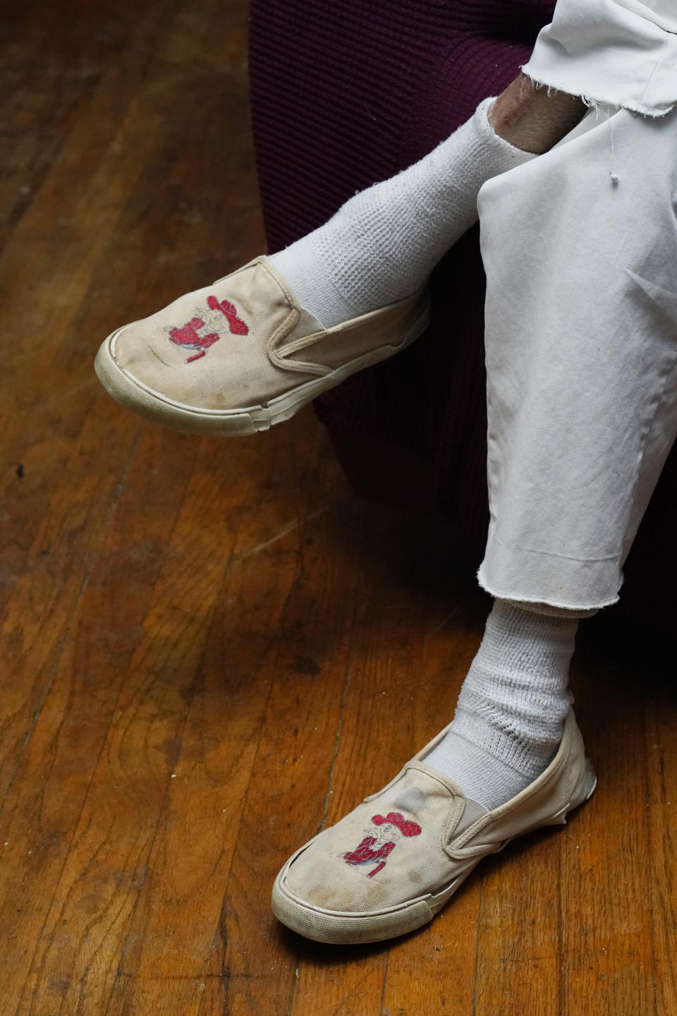 James Meredith, who integrated the University of Mississippi as its first Black student in 1962, wears an old pair of shoes with Col. Reb, a mascot the school no longer uses, at his home in Jackson, Miss., Thursday, Oct. 28, 2021. A person close to Meredith is selling “New Miss” merchandise and trying to trademark a logo with cursive script that is nearly identical to the university's Ole Miss logo. The university is fighting the trademark effort. (AP Photo/Rogelio V. Solis)