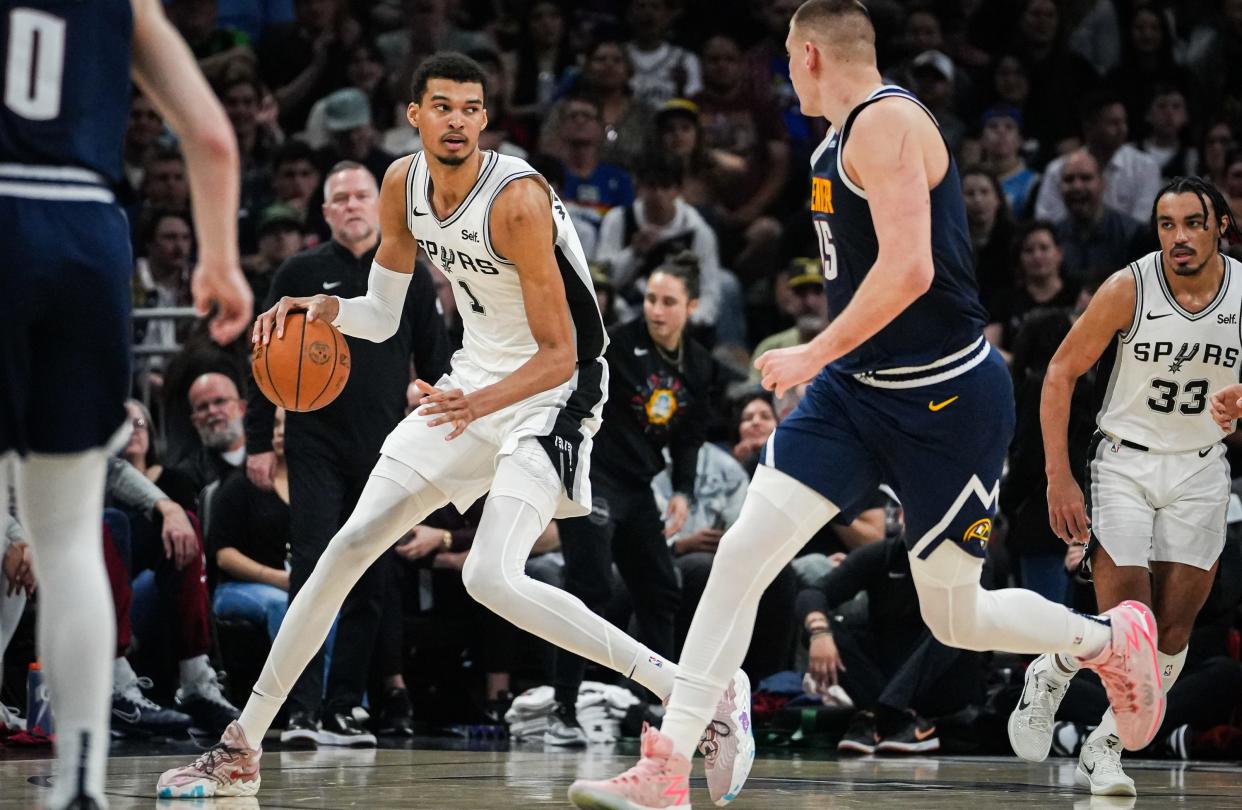 Spurs center Victor Wembanyama brings the ball down the court during the second quarter of Friday night's loss to Denver. The rookie has been on a tear since the All-Star break, averaging 21.6 points, 4.9 assists, 11.8 rebounds, 2.0 steals and 4.6 blocks,