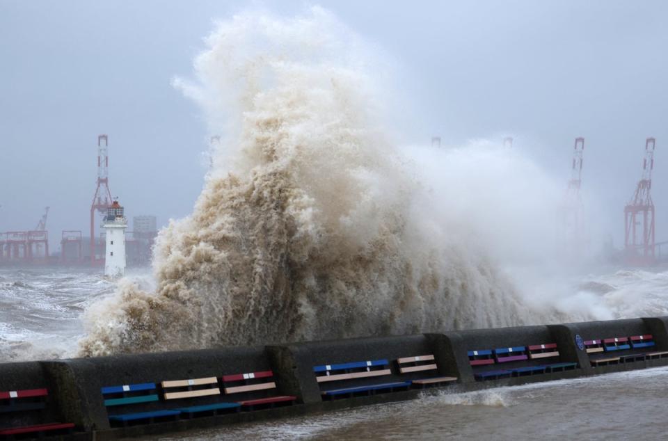 Waves crash over the sea wall during a storm in Brighton (Reuters)