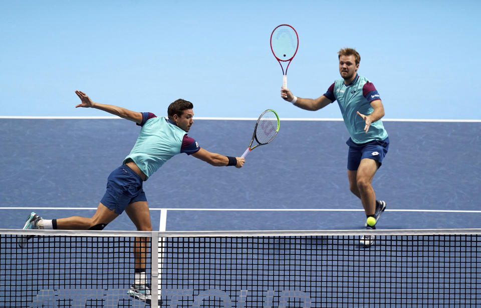 Kevin Krawietz and Andreas Mies of Germany, in action against Croatia's Nikola Mektic and Netherland's Wesley Koolhof, during their doubles match on day one of the ATP Finals tennis championship at The O2 Arena, London, Sunday Nov. 15, 2020. (John Walton/PA via AP)