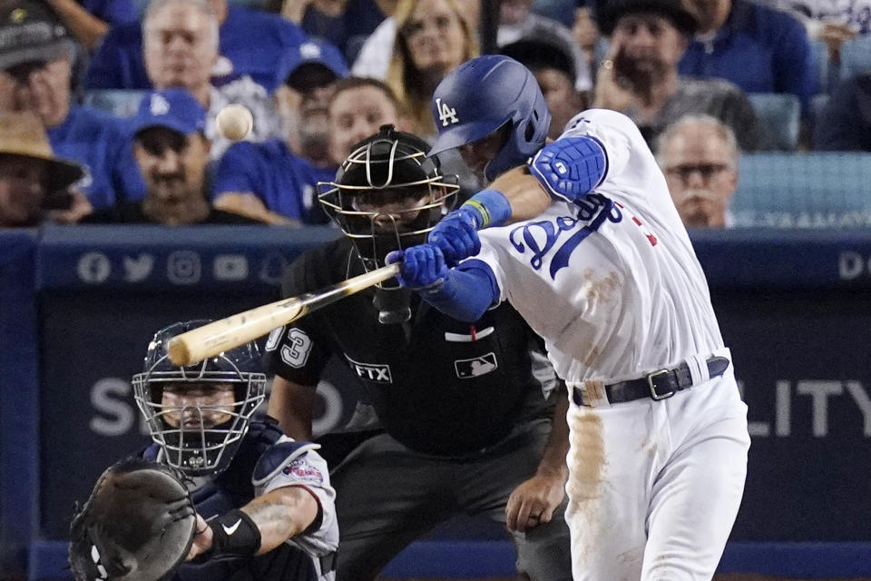 Los Angeles Dodgers' Chris Taylor, right, hits a solo home run while Minnesota Twins relief catcher Gary Sanchez watches along with home plate umpire Nestor Ceja during the sixth inning of a baseball game Wednesday, Aug. 10, 2022, in Los Angeles. (AP Photo/Mark J. Terrill)