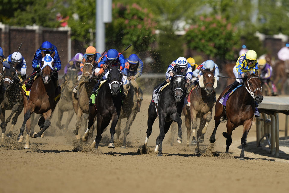 Horses round the fourth turn during the 149th running of the Kentucky Oaks horse race at Churchill Downs Friday, May 5, 2023, in Louisville, Ky. (AP Photo/Brynn Anderson)