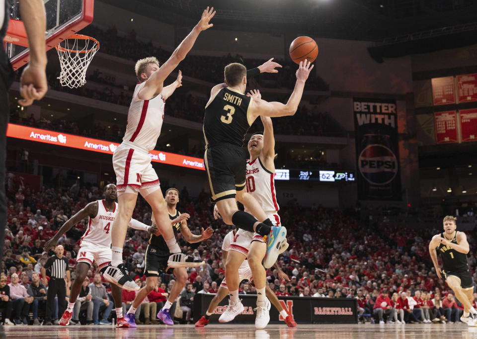 Purdue's Braden Smith, center, passes the ball away from Nebraska's Rienk Mast, left, and Keisei Tominaga during the second half of an NCAA college basketball game Tuesday, Jan. 9, 2024, in Lincoln, Neb. Nebraska won 88-72. (AP Photo/Rebecca S. Gratz)