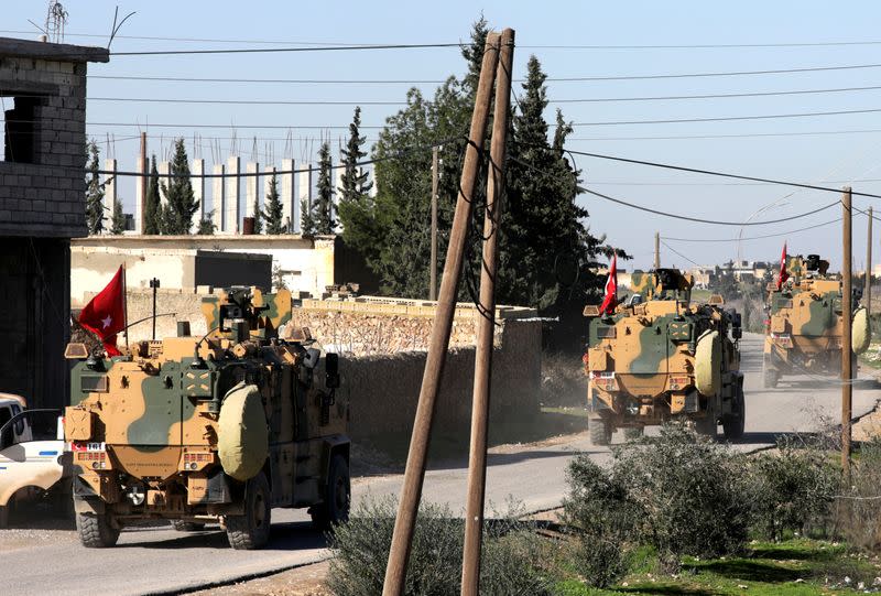 FILE PHOTO: Turkish military vehicles drive at Manbij countryside