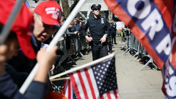 PHOTO: Police stand between supporters of former President Donald Trump and counter-protesters who are being kept apart outside of the Manhattan Criminal Court before his arraignment, April 4, 2023, in New York City. (Spencer Platt/Getty Images)