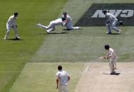 Australia's captain Steve Smith (top) takes a catch in front of team-mate Shaun Marsh to dismiss New Zealand's Bradley-John Watling (R) for seven runs during the third day of the third cricket test match at the Adelaide Oval, in South Australia, November 29, 2015. REUTERS/David Gray