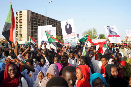 Sudanese demonstrators celebrate after Defence Minister Awad Ibn Auf stepped down as head of the country's transitional ruling military council, as protesters demanded quicker political change, near the Defence Ministry in Khartoum, Sudan April 13, 2019. REUTERS/Stringer