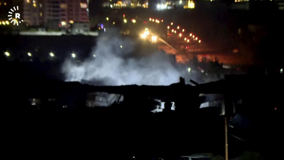 This image taken from video provided by Rudaw TV shows smoke rising from a building hit by a strike in Irbil, Iraq, Tuesday, Jan. 16, 2024. Iran has announced that it launched strikes against a “spy headquarters and the gathering of anti-Iranian terrorist groups” shortly after missiles hit an area near the U.S. consulate in Irbil, the seat of Iraq’s semi-autonomous Kurdish region. (Rudaw TV via AP)