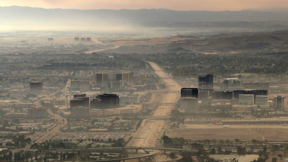 Buildings are seen through the thick smoke of the Santiago Fire in Irvine, California. - Kevork Djansezian/AP