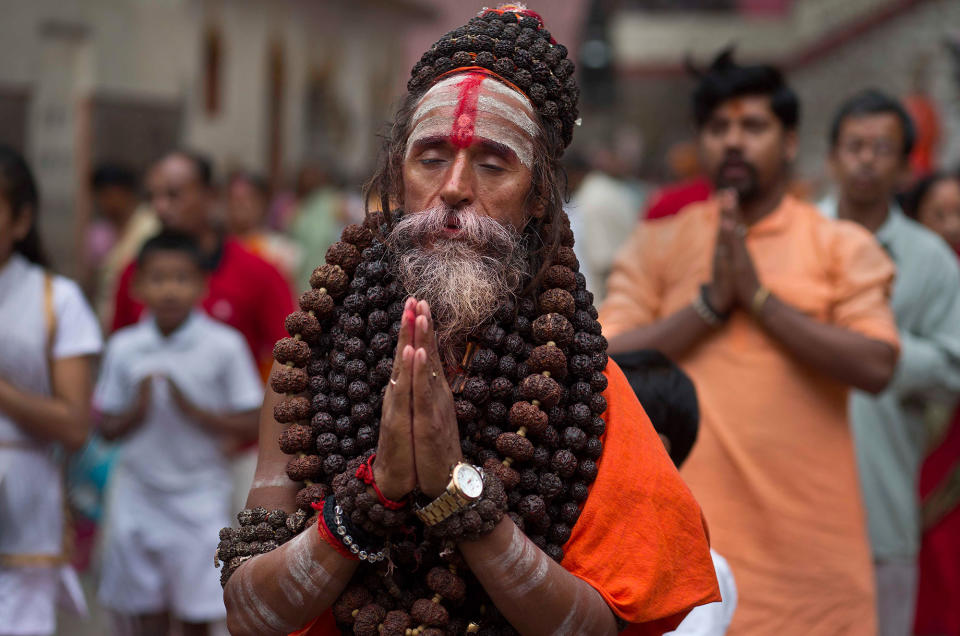 <p>An Indian Sadhu or Hindu holy man performs Yoga as others follow during the International Yoga Day at Kamakhya temple in Gauhati, India, Wednesday, June 21, 2017. (Photo: Anupam Nath/AP) </p>