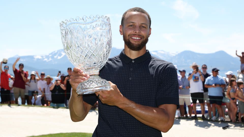 Curry poses with the trophy. - Isaiah Vazquez/Getty Images