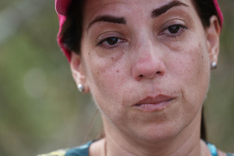 <p>Lizzy Alicea becomes emotional as she speaks about the lack of aide that is reaching her mother’s home town September 24, 2017 in Hayales de Coamo, Puerto Rico. Puerto Rico experienced widespread damage after Hurricane Maria, a category 4 hurricane, passed through. (Photo: Joe Raedle/Getty Images) </p>