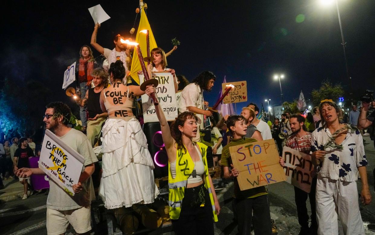 People take part in a protest against Israeli Prime Minister Benjamin Netanyahu's government