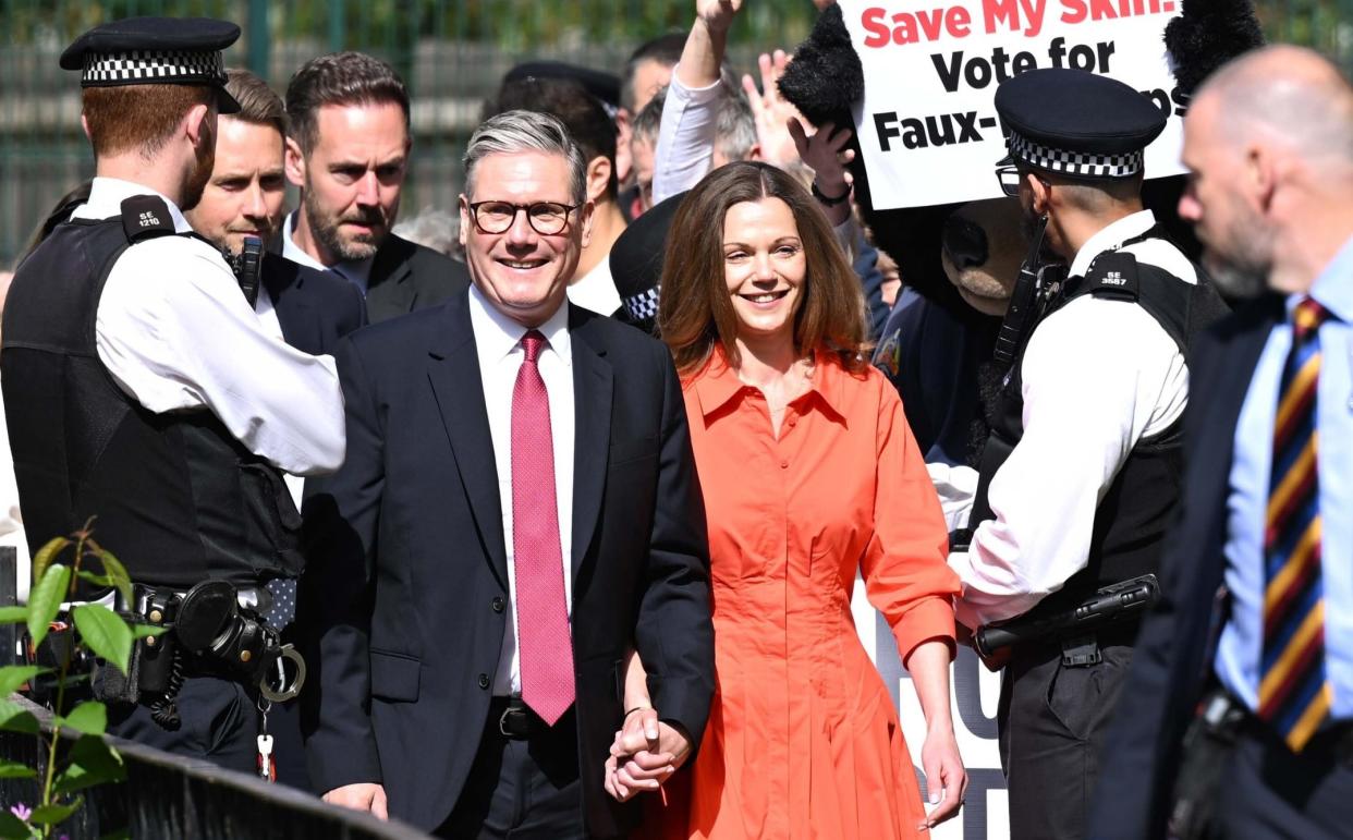 Sir Keir Starmer and his wife Victoria walking hand-in-hand