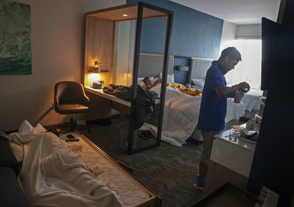 Pedro Escalona, 24, right, and three of his fellow migrants makes coffee in a hotel room paid for by a labor company that had brought them from New York for hurricane cleanup.