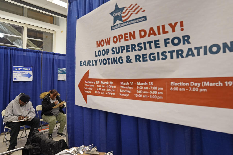 Voters fill out voter registration form at Chicago Loop Super Site in Chicago, Tuesday, March 19, 2024. Illinois residents will vote Tuesday to narrow Democratic and GOP candidate fields in key U.S. House races. (AP Photo/Nam Y. Huh)