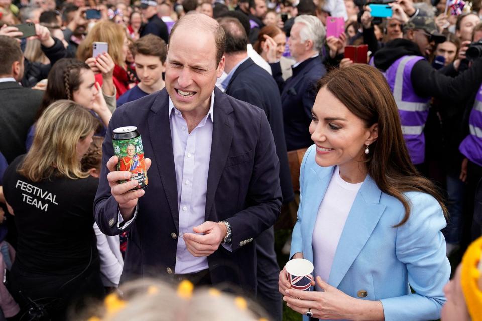 britains prince william, prince of wales, reacts as holds a can of organic coronation ale, while he and britains catherine, princess of wales meet members of the public on the long walk near windsor castle, west of london may 7, 2023, ahead of the coronation concert thousands of local street parties took place on may 7, 2023 on the second day of events to mark the coronation of king charles iii, ending with a concert in front of 20,000 people at windsor castle photo by andrew matthews pool afp photo by andrew matthewspoolafp via getty images