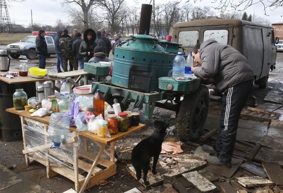 Pro Russian activists camped near the armory Ukrainian army to prevent the export of arms and ammunition in the village of Poraskoveyevka, eastern Ukraine, Thursday, March 20, 2014. The disheveled men barricading the muddy lane leading into a military base in this eastern Ukraine village say they're taking a stand to defend Russian-speakers. (AP Photo/Sergei Grits)