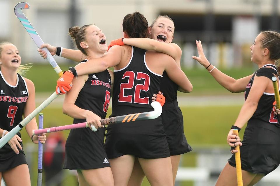 Rutgers field hockey player Lucy Bannatyne (22) is being hugged by Katie Larmour with Bridy Molyneaux (8) at left as they celebrate their 2-1 win over Delaware in the NCAA Tournament last fall.