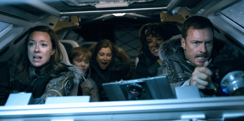 Molly Parker, Max Jenkins, Mina Sundwall, Parker Posey, and Toby Stephens in a vehicle in scene from "Lost in Space"