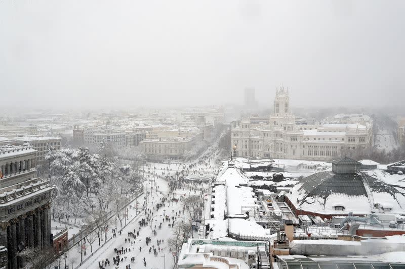People are seen from the rooftop of the Circulo de Bellas Artes cultural center during a heavy snowfall in Madrid