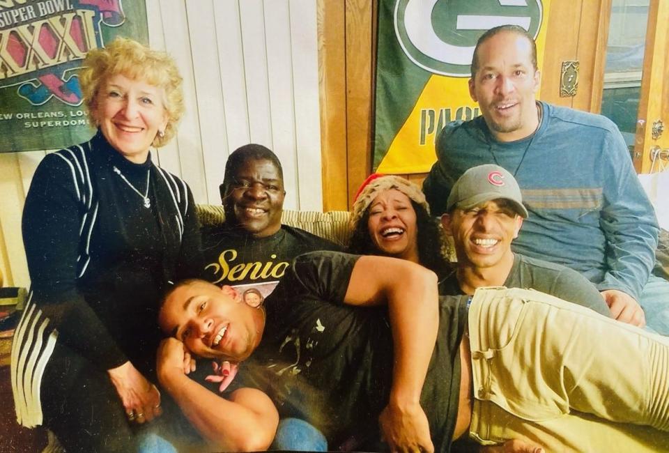 Glenn Patterson, seated second to left, smiles in an undated photo with his family — wife, Mary, left, and their children.