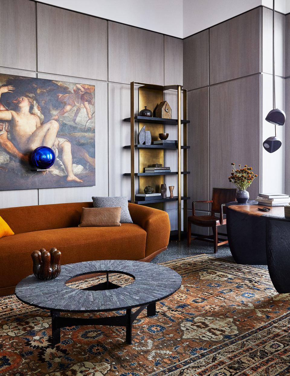 In the husband’s office, an artwork by Jeff Koons hangs above a custom sofa in a Rogers & Goffigon Wool. Pia Manu cocktail table; Kaare Klint chair from Dienst + Dotter; antique Persian Rug.