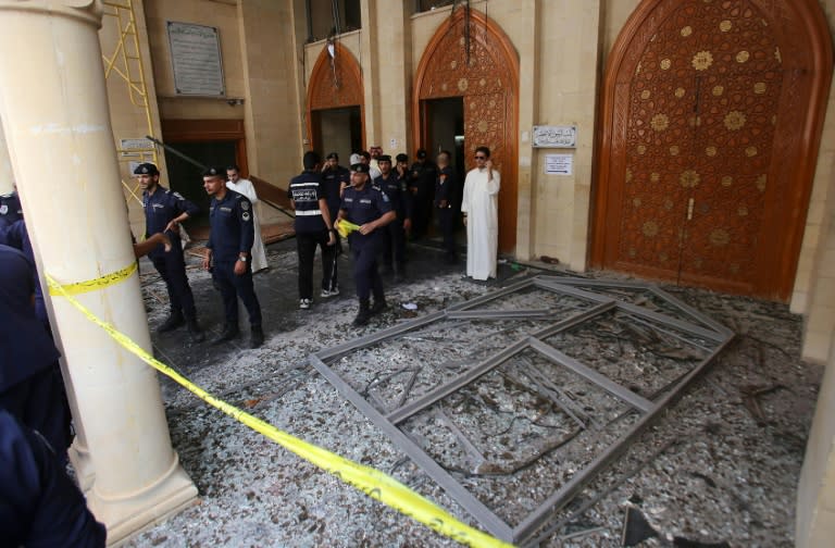 Kuwaiti security forces gather outside the Shiite Al-Imam al-Sadeq mosque after it was targeted by a suicide bombing during Friday prayers on June 26, 2015, in Kuwait City