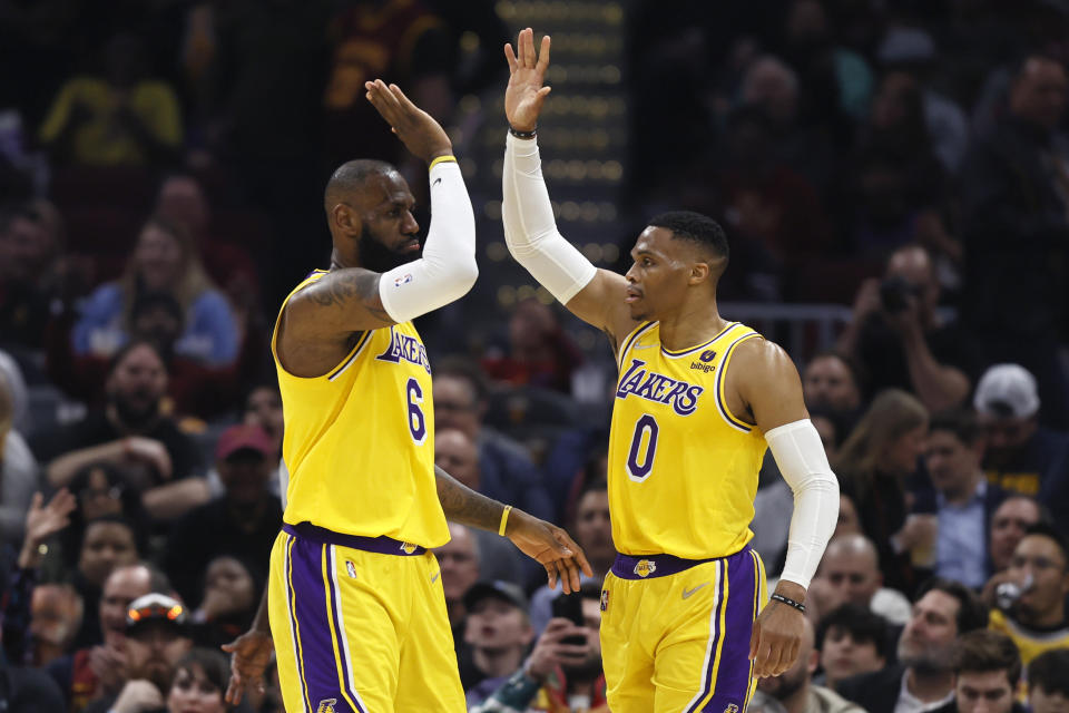 Los Angeles Lakers' LeBron James (6) and Russell Westbrook (0) play against the Cleveland Cavaliers during the first half of an NBA basketball game, Monday, March 21, 2022, in Cleveland. (AP Photo/Ron Schwane)