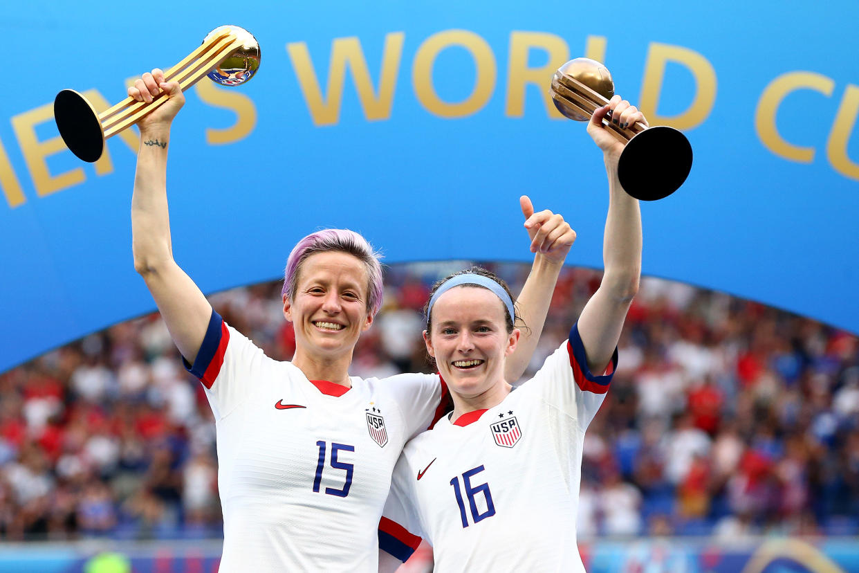 LYON, FRANCE - JULY 07: Megan Rapinoe with her Gold Ball award, celebrates with Rose Lavelle and her Bronze Ball award after the 2019 FIFA Women's World Cup France Final match between The United State of America and The Netherlands at Stade de Lyon on July 07, 2019 in Lyon, France. (Photo by Maddie Meyer - FIFA/FIFA via Getty Images)