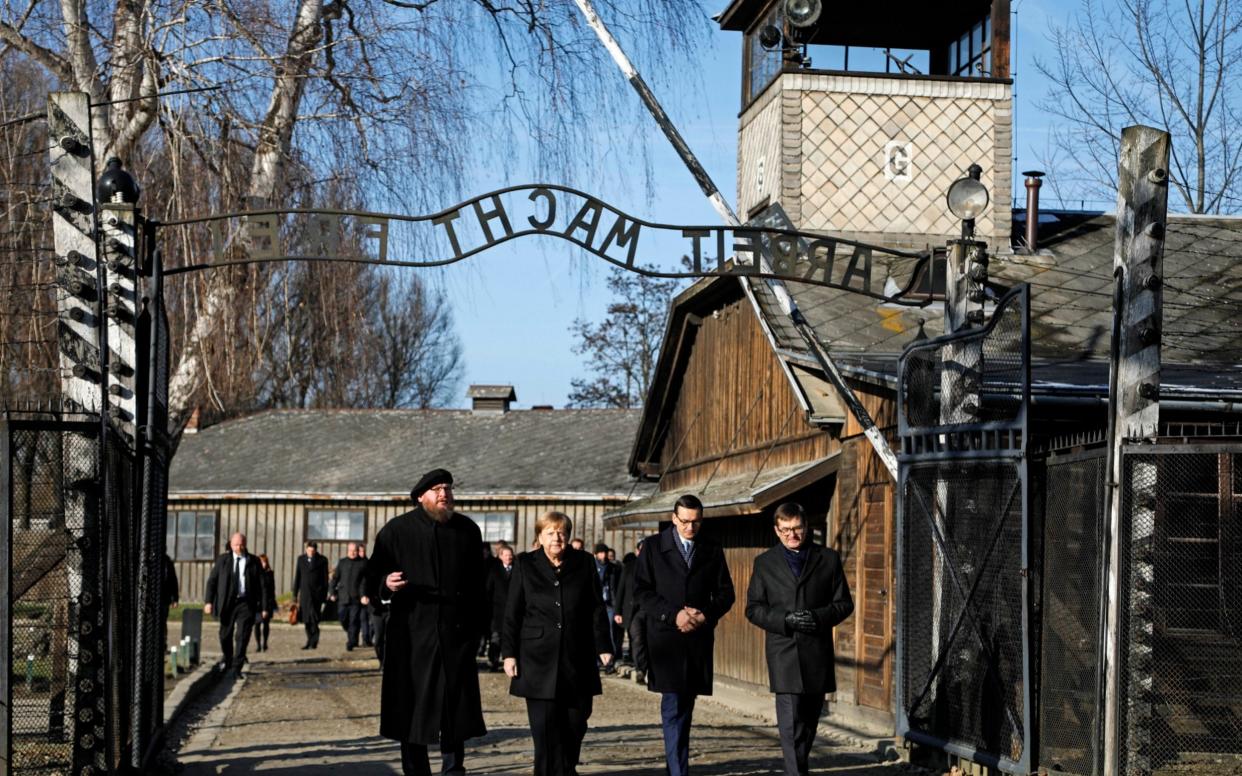 Angela Merkel is the third postwar German leader to visit Auschwitz - AP