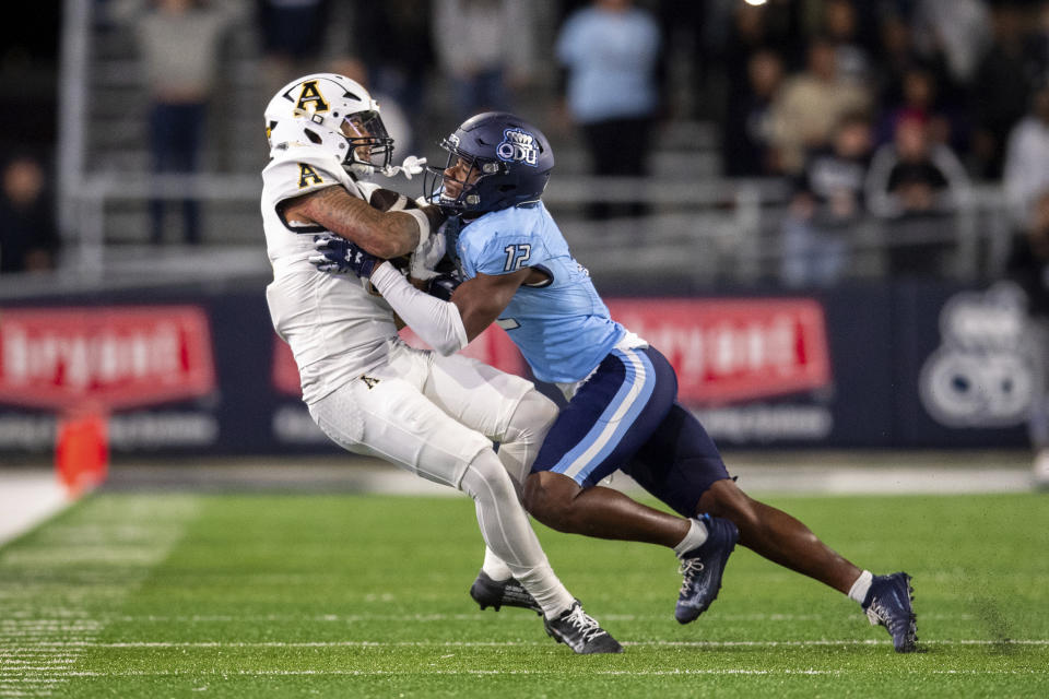 Appalachian State wide receiver Kaedin Robinson, left, is tackled by Old Dominion safety Tahj Ra-El, right, during the second half of an NCAA college football game Saturday, Oct. 21, 2023, in Norfolk, Va. (AP Photo/Mike Caudill)