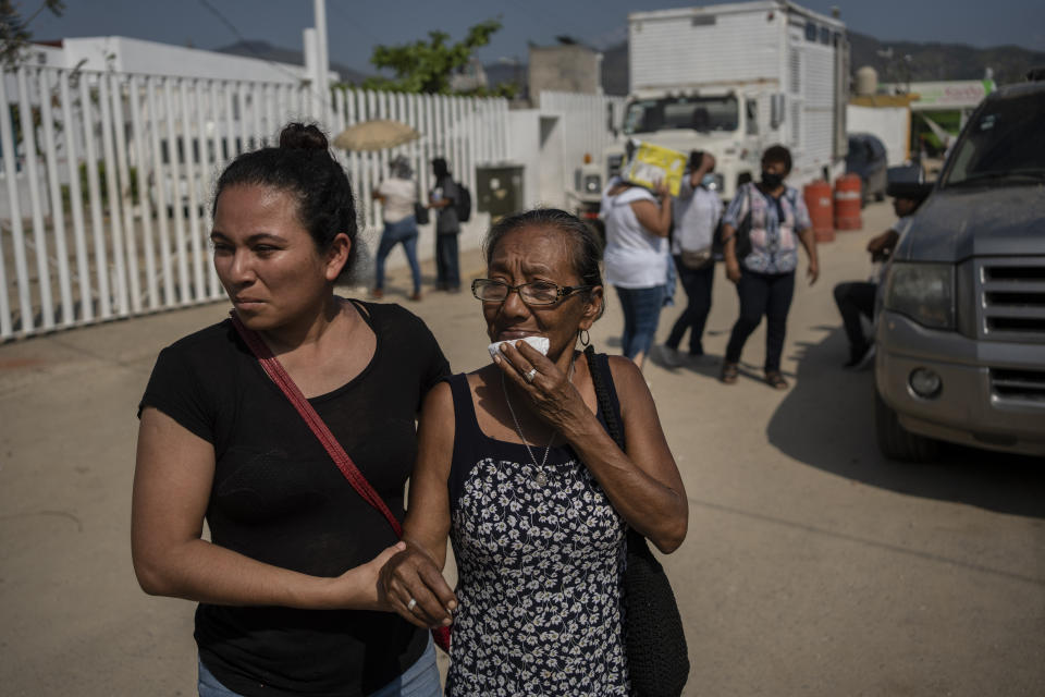 Relatives of hurricane Otis victims seek information outside a morgue in Acapulco, Mexico, Sunday, Oct. 29, 2023. Mexican authorities have raised the toll to 48 dead from the Category 5 storm that struck the country's southern Pacific coast. (AP Photo/Felix Marquez)