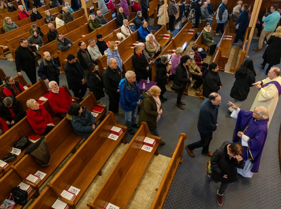 Worshippers receive ashes during Ash Wednesday Mass at St. John’s Catholic Church Wednesday.