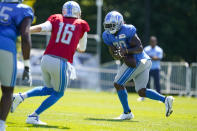 Detroit Lions running back Jamaal Williams (30) fumbles a pitch from quarterback Jared Goff (16) during a joint practice with the Indianapolis Colts at NFL football training camp in Westfield, Ind., Wednesday, Aug. 17, 2022. (AP Photo/Michael Conroy)