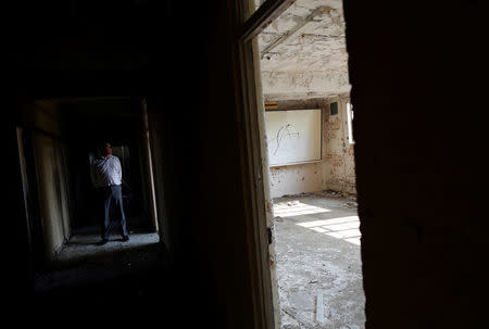 Chairman and founder of Bletchley Park Capital Partners Ltd Tim Reynolds looks around G-block where the National College of Cyber Education will be based at Bletchley Park in Milton Keynes, Britain, September 15, 2016. Picture taken September 15, 2016. REUTERS/Darren Staples