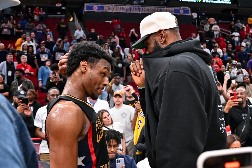 Bronny James, left, speaks with his father, LeBron James of the Los Angeles Lakers, after the McDonald's All American Game at Toyota Center, March 28, 2023 in Houston.