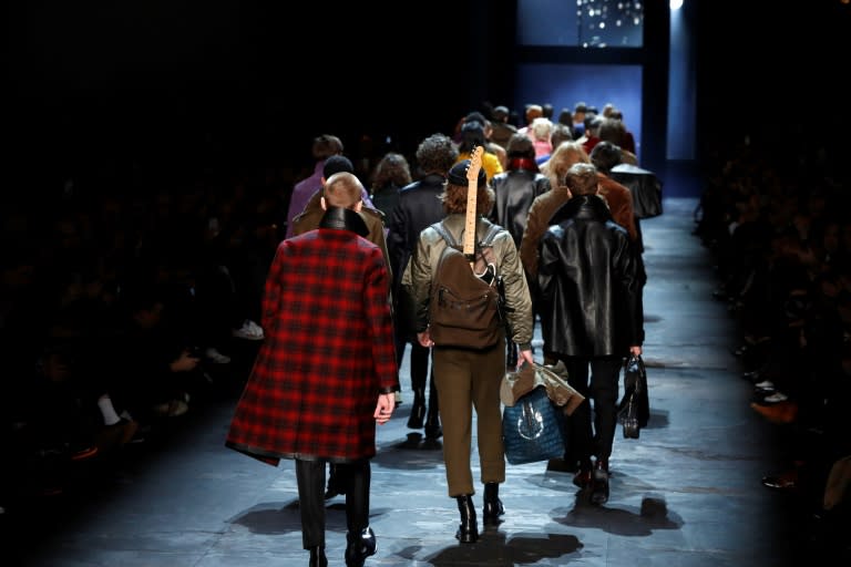 Colombian-born fashion designer Haider Ackermann's Berluti suits of browns and blacks were paired with coats in rich reds, blues and gold and woolly halo collars