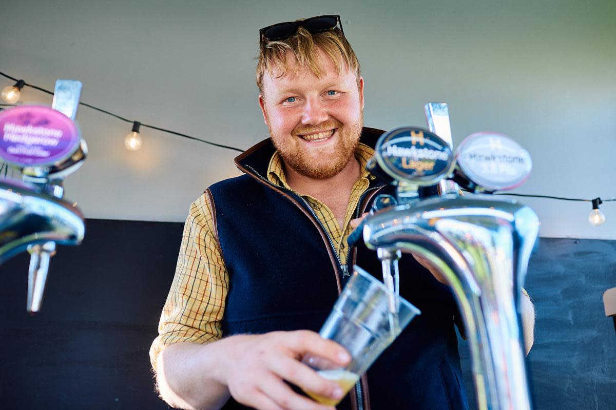 Kaleb Cooper pulling a non-Hawstone's pint at Park Fair at Great Tew Estate <i>(Image: Nick Emm)</i>