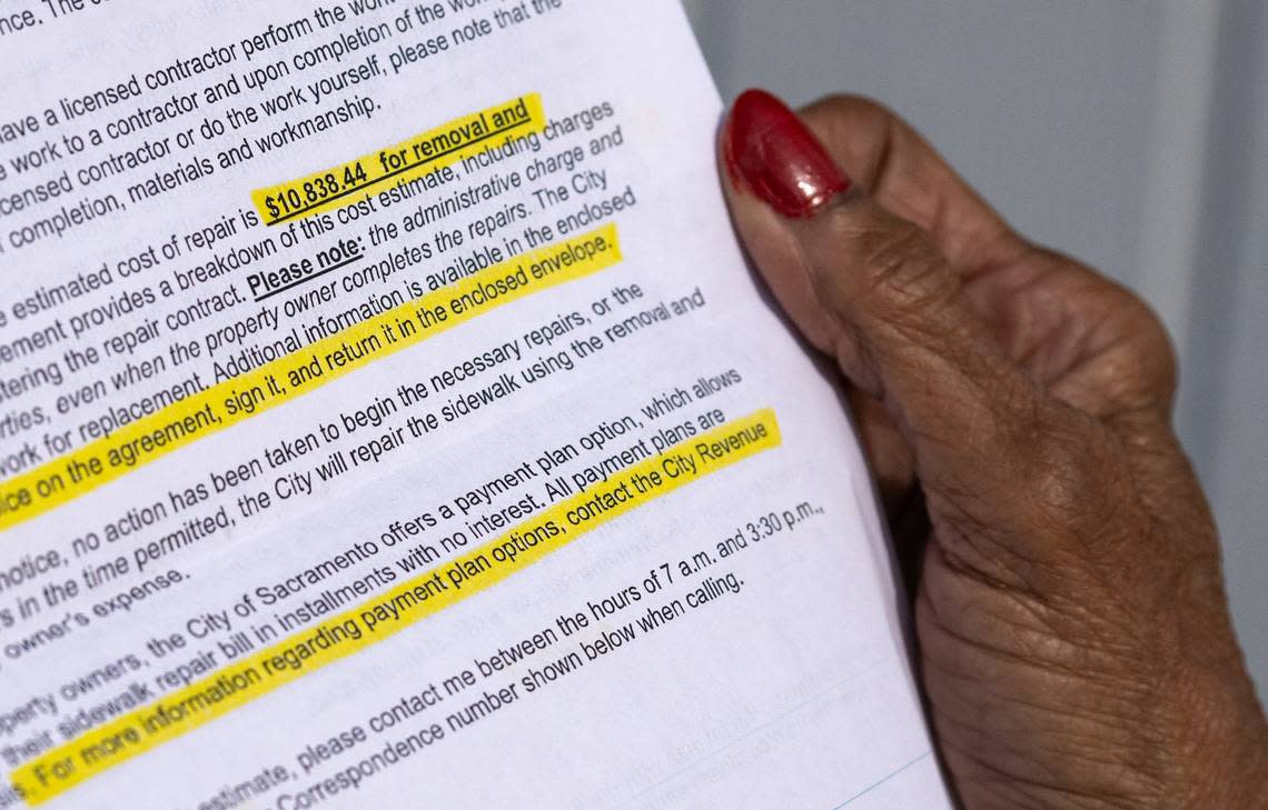 Ola Gipson holds a letter in November from the city of Sacramento asking her to pay $10,838 to replace the sidewalk in front of her home in the Valley Hi neighborhood.