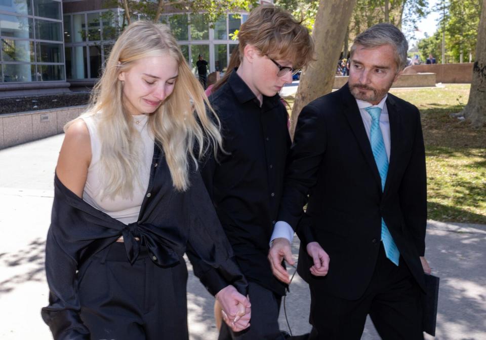 Dr. Peter Grossman leaves a Van Nuys courthouse with his two children, Nicholas and Alexis.