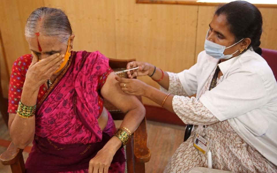 A woman receives a dose of a Covid-19 vaccine in Bangalore, India on 13 August 2021 - Jagadeesh Nv/Shutterstock