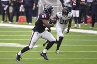 Houston Texans tight end Darren Fells (87) runs for a touchdown past Jacksonville Jaguars free safety Jarrod Wilson (26) after making a catch during the first half of an NFL football game Sunday, Oct. 11, 2020, in Houston. (AP Photo/Eric Christian Smith)