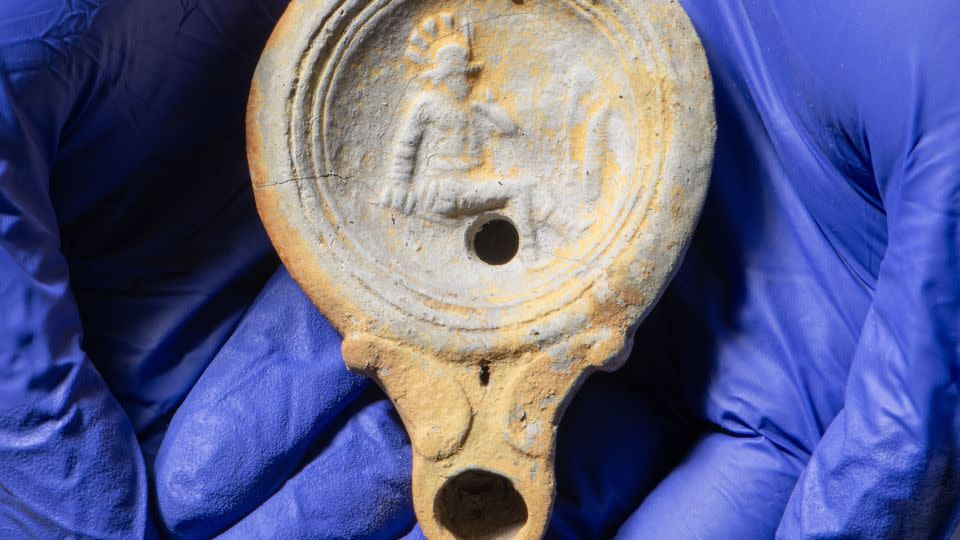 This decorated Roman lamp from a cremation was also found at the site. - Museum of London Archaeology