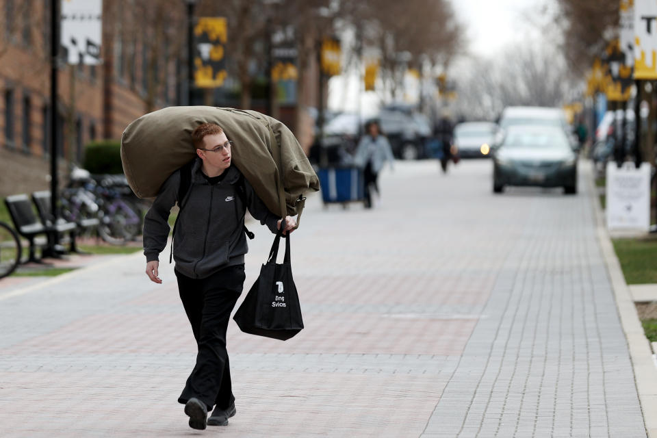 TOWSON, MARYLAND - MARCH 11: Towson University student Garrett Lang of Frederick, Maryland carries his belongings out of the dorms as the school shut down days before the start of the scheduled spring break on March 11, 2020 in Towson, Maryland. Universities across the nation have closed through spring break as the novel Coronavirus spreads. (Photo by Rob Carr/Getty Images)