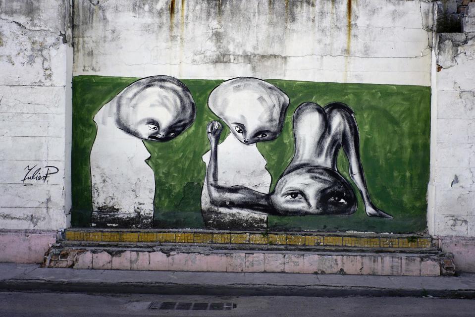 In this Feb. 12, 2017 photo, the work of urban artist Yulier P. adorns a wall on a street in Old Havana, Cuba. The 27-year-old artist, whose full name is Yulier Rodríguez, has not catalogued his paintings, which typically take about 40 minutes to complete, but estimates that he has done around 150, mostly in Havana. (AP Photo/Ramon Espinosa)