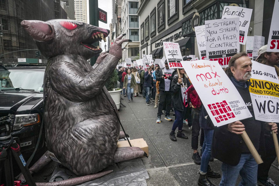 File - Scabby, a giant inflatable rat used by organized labor, stands on the sidewalk as members of the The Writers Guild of America picket outside an NBC event on Tuesday, May 2, 2023, in New York. For decades, inflatable rats like Scabby have been looming over union protests, drawing attention to construction sites or companies with labor disputes. (AP Photo/Bebeto Matthews, File)