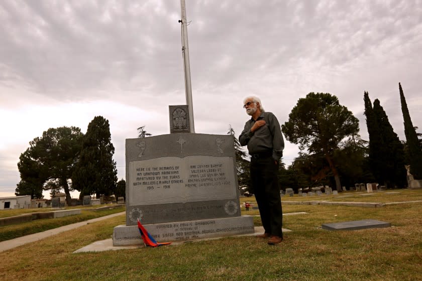 FRESNO, CA - NOVEMBER 17, 2020 - Varoujan Der Simion, 59, places his hand over his heart at the Grave of the Unknown Martyr from Der El Zor Desert in the Ararat Cemetery in Fresno on November 17, 2020. The grave symbolizing the lives lost in the Armenian Genocide whose names are not remembered and bodies went unburied. (Genaro Molina / Los Angeles Times)
